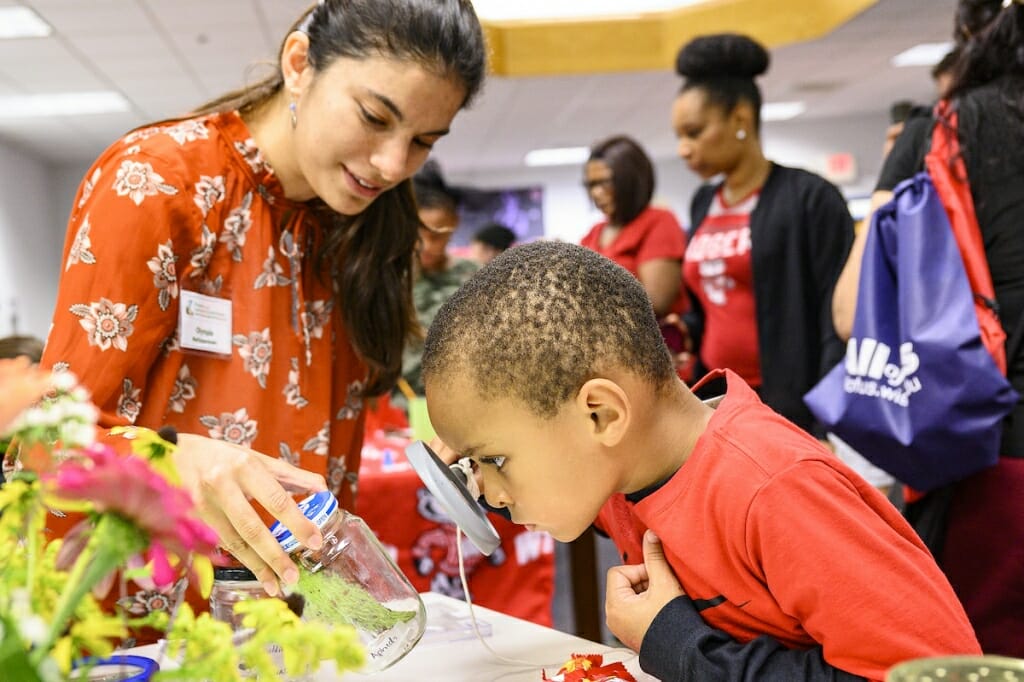 Photo: A woman shows a boy some plants.