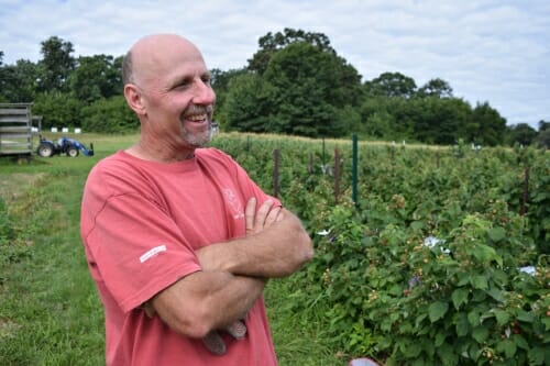 Photo: Ed standing next to plants