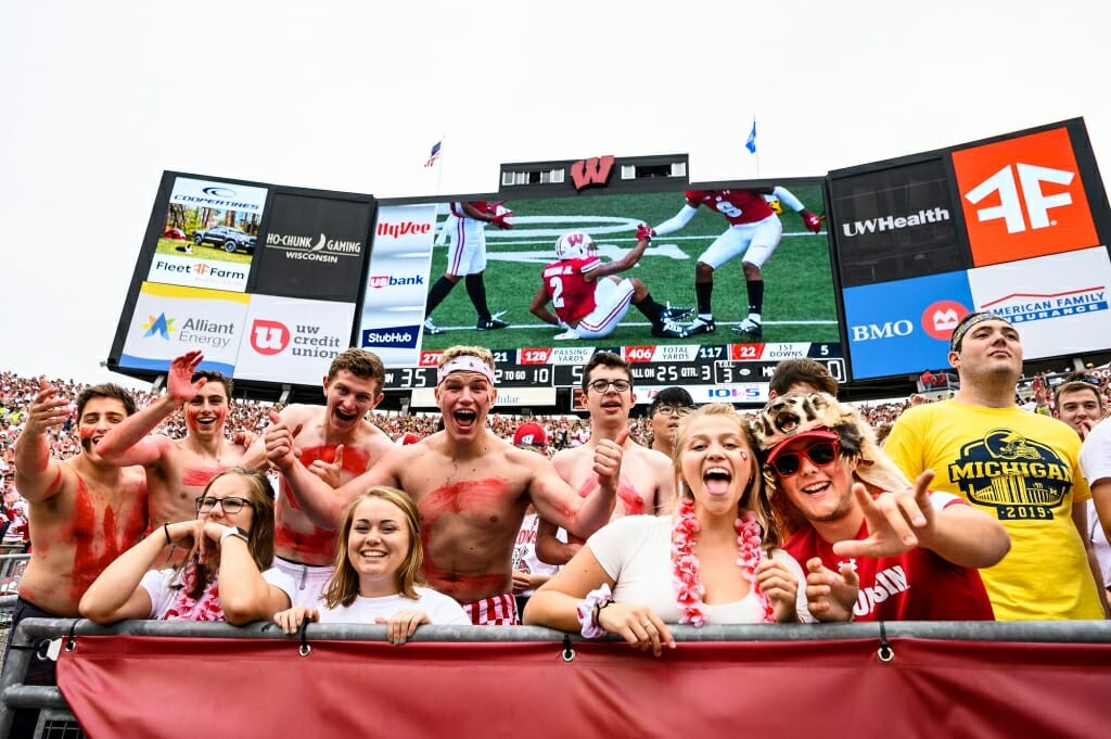 A Michigan fan appears not to be enjoying the game as much as neighboring Badger fans.