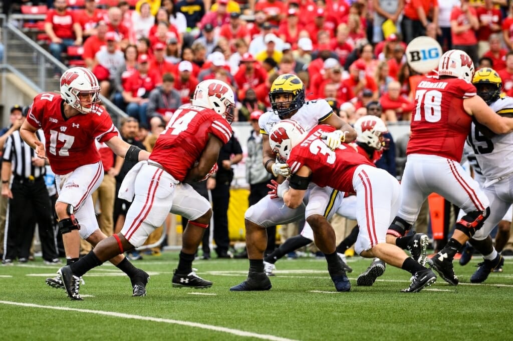 Wisconsin quarterback Jack Coan (17) hands off the football to running back Nakia Watson (14) in 4th quarter play against the Michigan Wolverines at Camp Randall Stadium at the University of Wisconsin-Madison on Sept. 21, 2019. Wisconsin won the game 35-14. (Photo by Jeff Miller / UW-Madison)