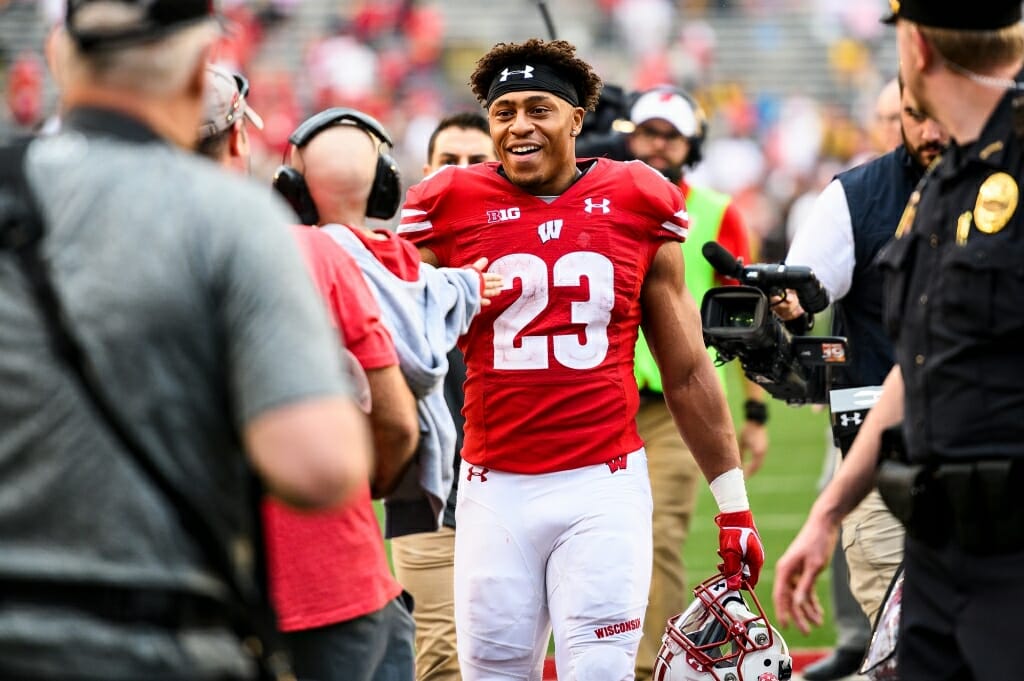 Wisconsin running back Jonathan Taylor (23) is tired but happy after his big game.