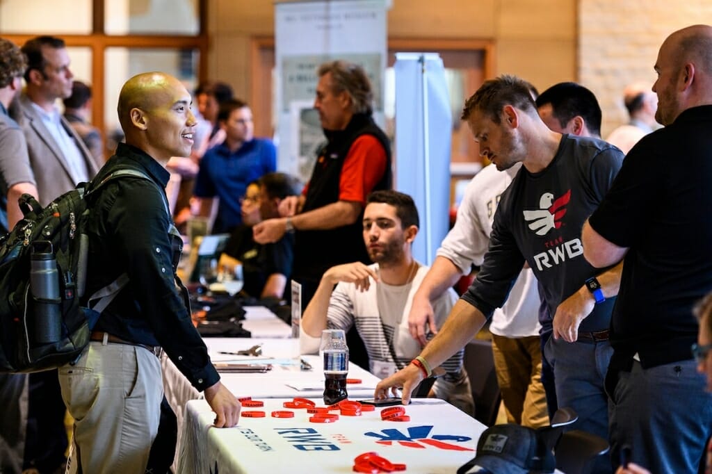 Photo: Student veteran standing at information table