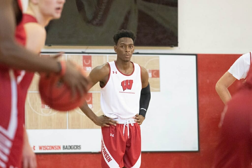 A basketball player stands on the court.