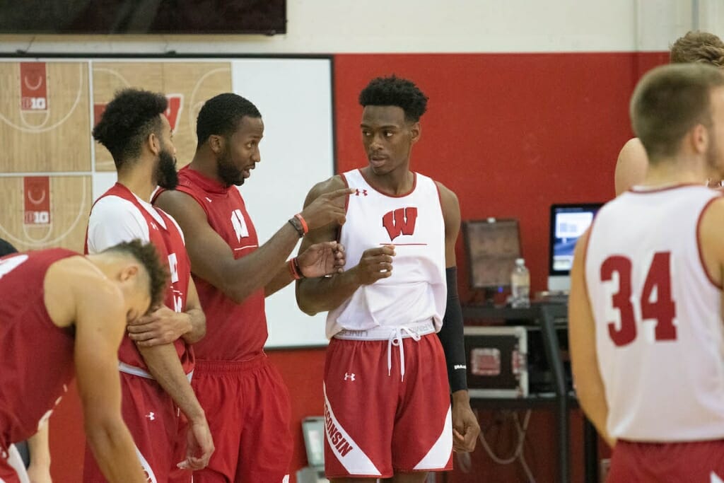 Photo: Basketball players talk during practice.