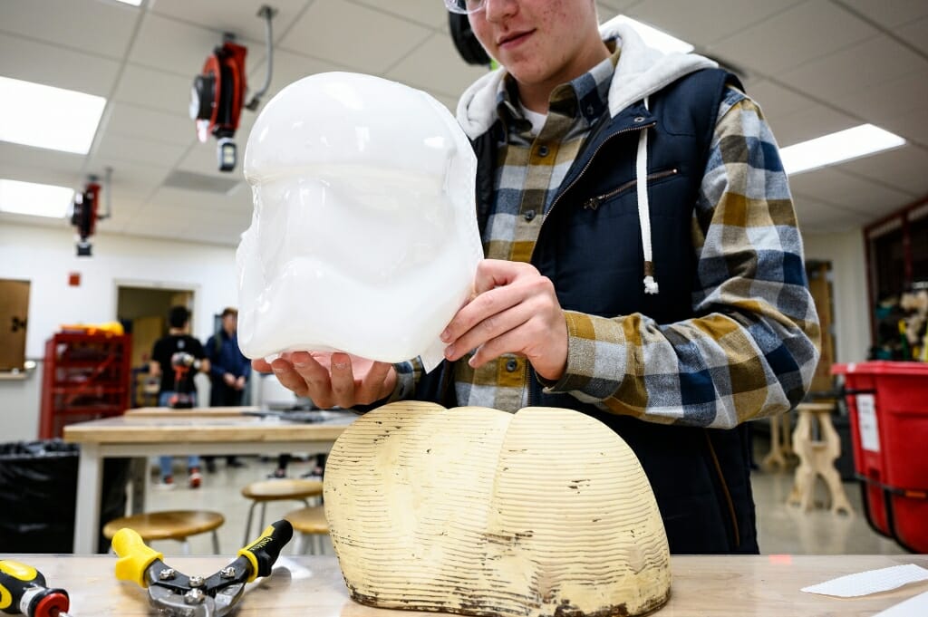 Photo: Person holding mask over mold