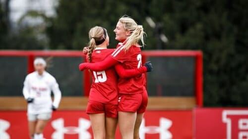 Photo: Two soccer players hug.