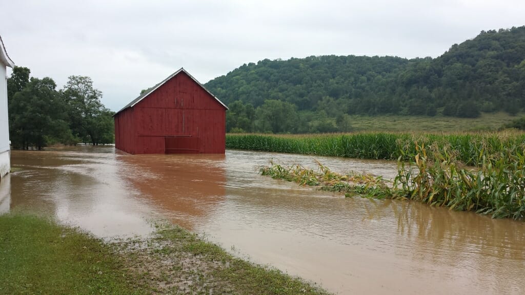 Photo: A field and barn are filled with water.