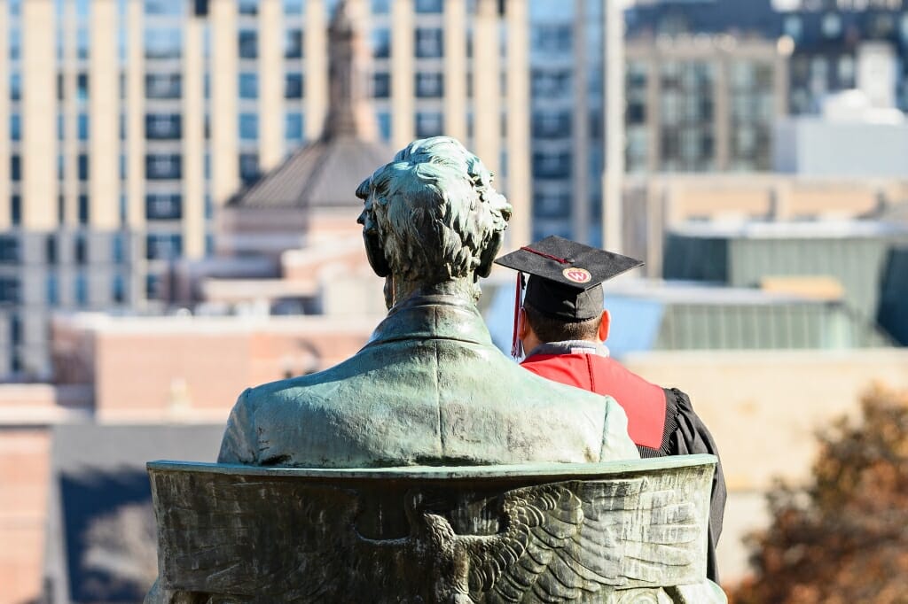 A soon-to-be-graduate poses for photos with the Abraham Lincoln statue in front of Bascom Hall during a professional photography session on Nov. 22. Winter commencement is Dec. 15.