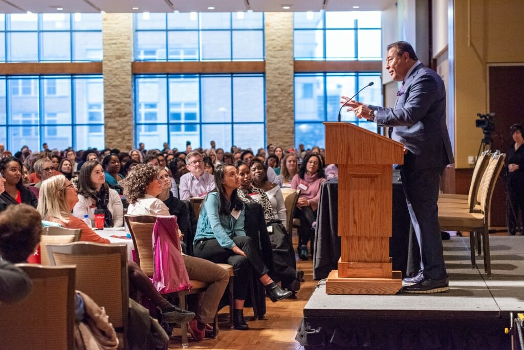 Photo: A man speaks to a crowd of people