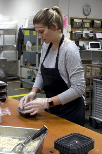 Photo: A woman packages some food.