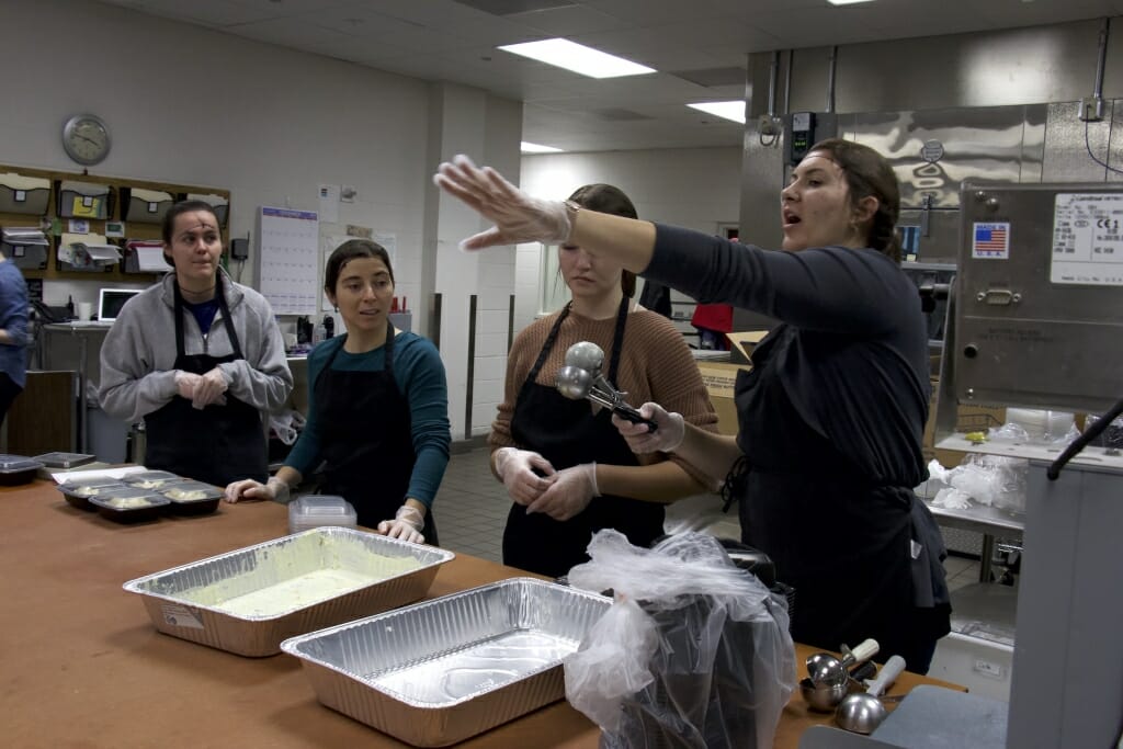 Photo: A group of people packages food.