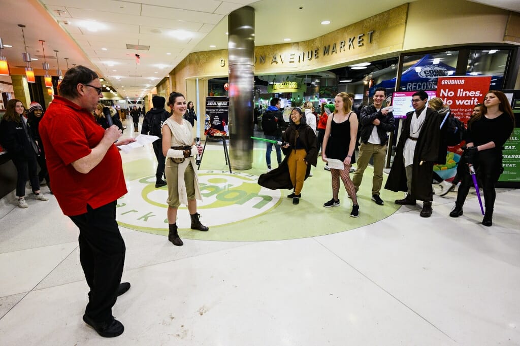 At left, food service assistant James Eliason introduces costume contestants.