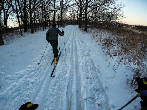 A first-person view of a person skiing in snow.