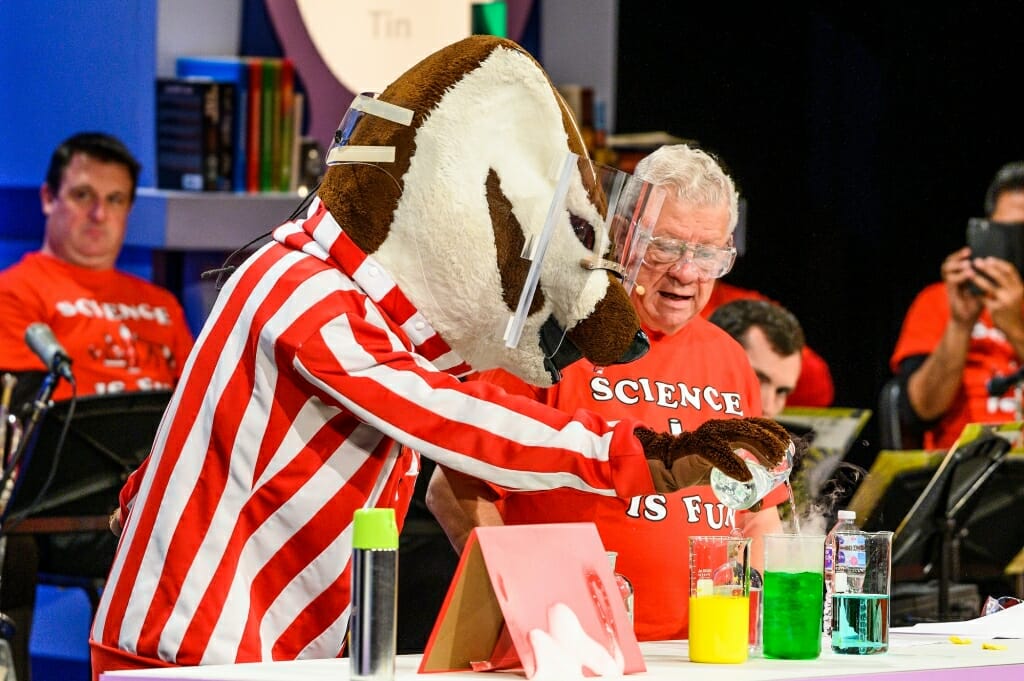 Photo of Bucky Badger pouring a chemical into a flask.