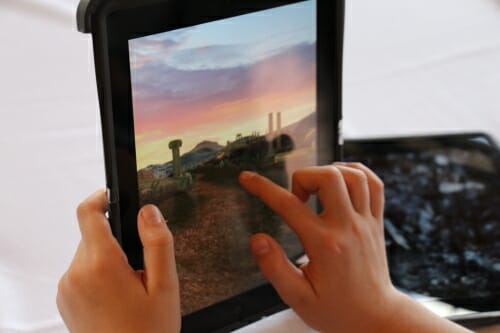 Photo: Hands of child tapping on tablet computer screen