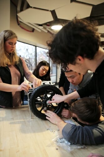 Photo: Students work on a dog wheelchair.