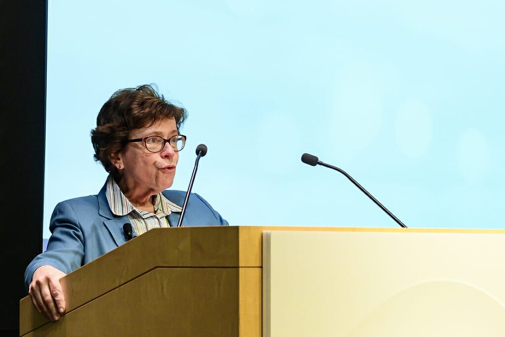 Photo: Rebecca Blank speaking into a microphone at a podium