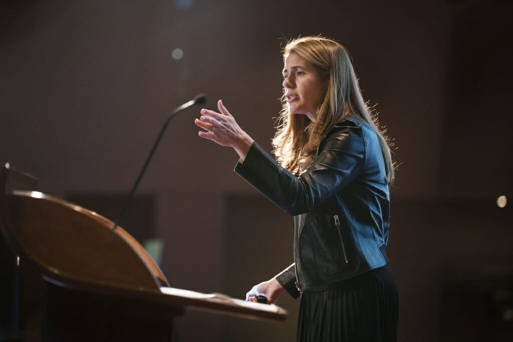 Photo: A woman speaks in a microphone.