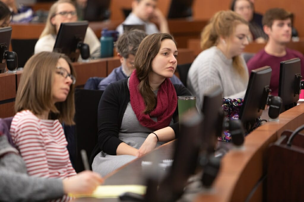 Photo: People in audience listening to panelists