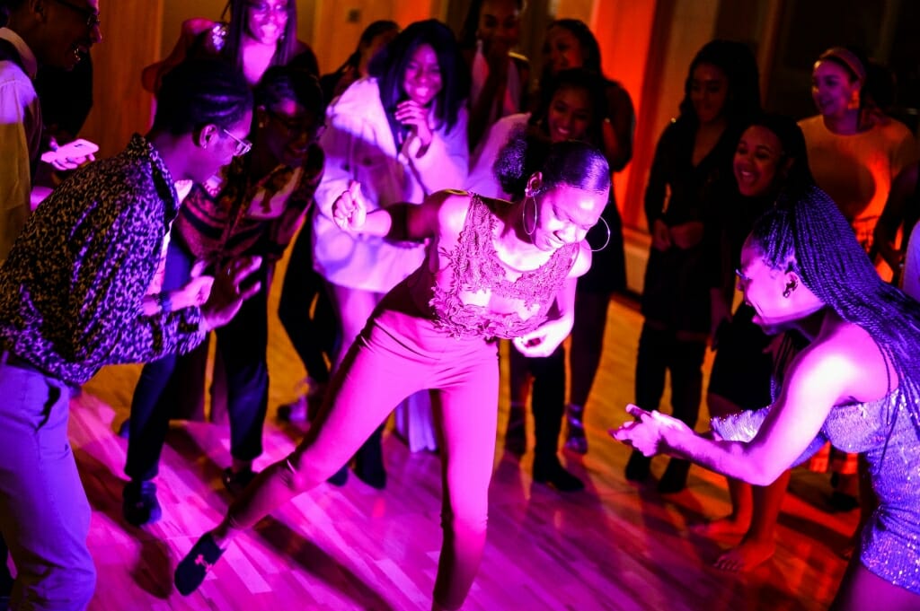 A woman dances in purple light.