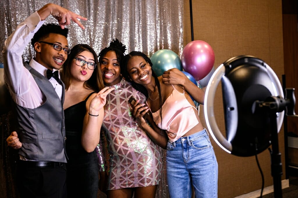 Four people smile for the camera.