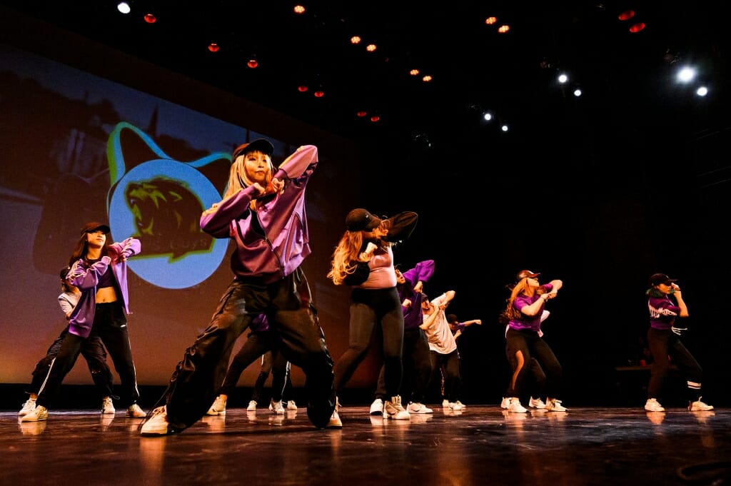 Dancers move across the stage.