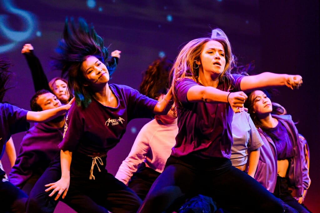 A dancer points to the crowd.