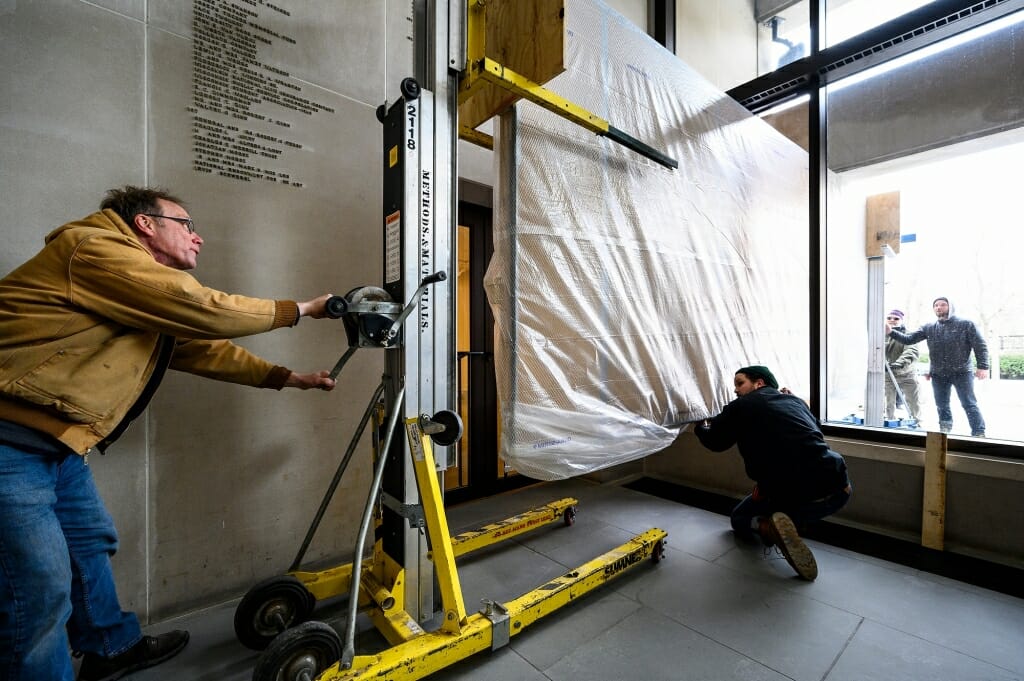 Mural lifted on a lift.