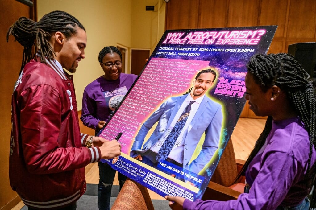 Freelon signs a poster following his talk.