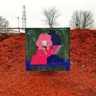 Painting standing on pile of red bark mulch