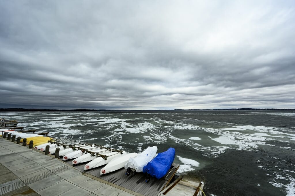 A stormy lake dotted with ice.