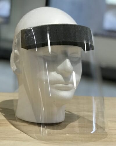 A clear plastic faceshield on a dummy.