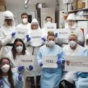 Workers at the Wisconsin State Laboratory of Hygiene show their gratitude for the free pizza delivery from 