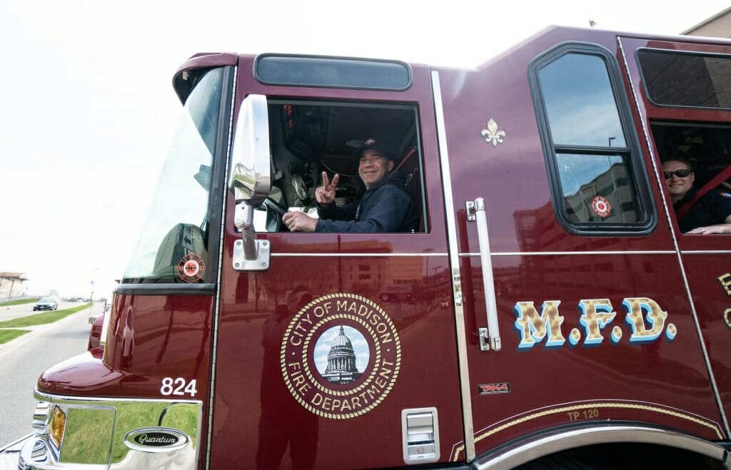 Closeup of fire truck driver making peace sign