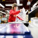 Staff member Susan Laufenberg fabricates and packages custom-made medical face shields.