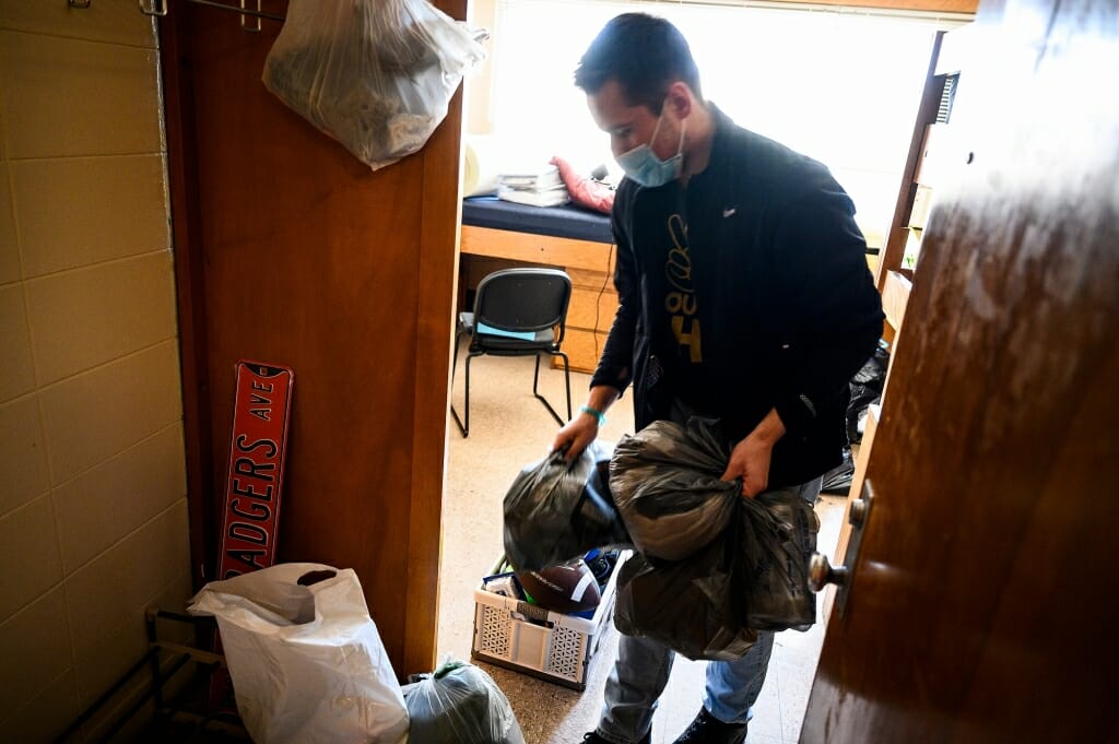 A student cleans out a room.