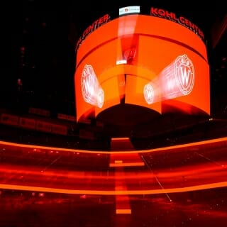 The interior of the Kohl Center bathed in red light.