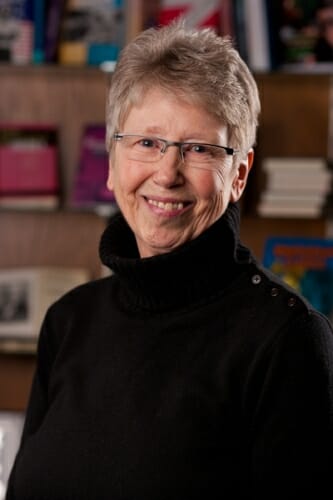 Portrait of Sharon Dunwoody in front of a wall with plaques on it