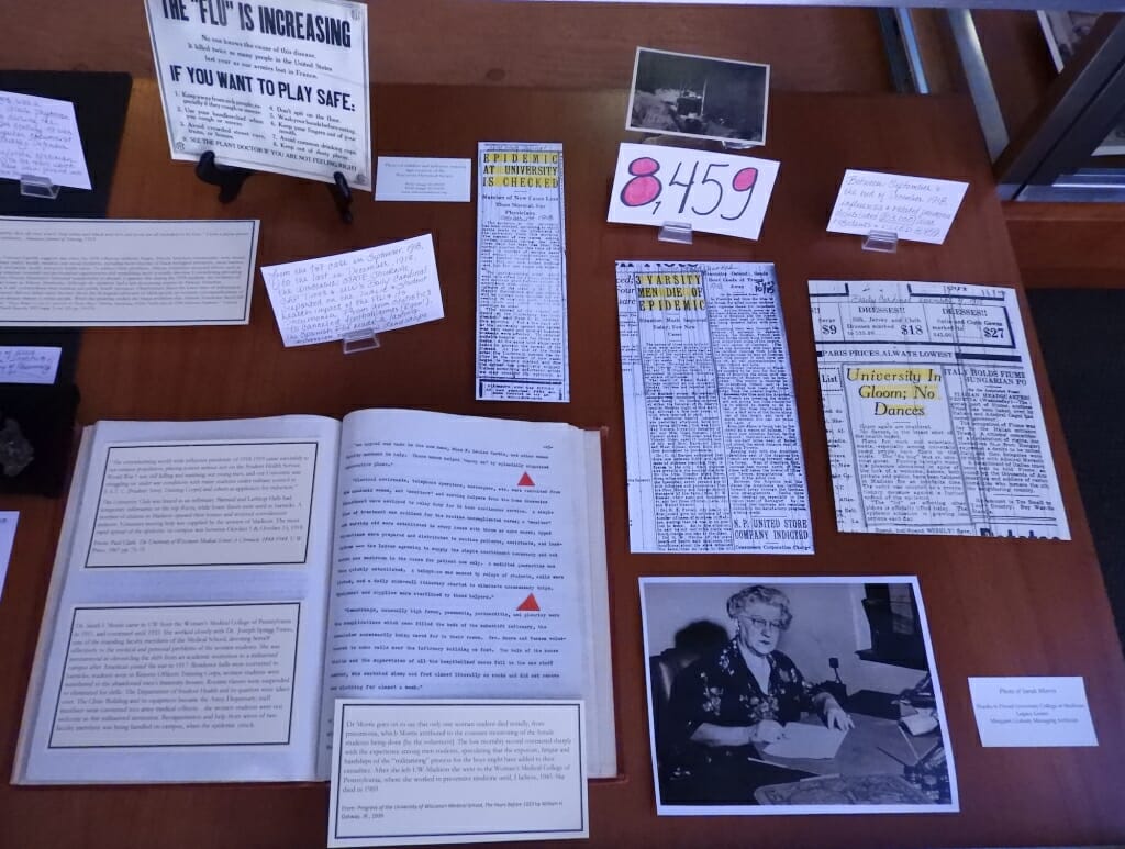 Books, photos and newspaper clippings in a display case