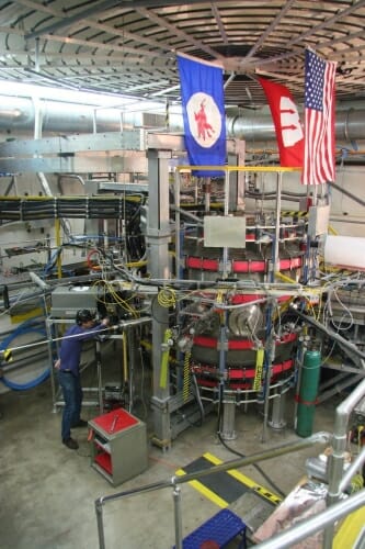 A researcher works on a compact spherical magnetic container