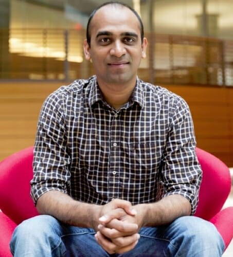 Portrait of Mohit Gupta seated in a building lobby