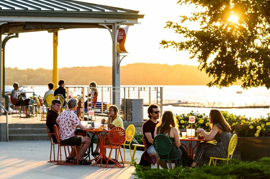 The sun sets over the lake as Terrace patrons look on.