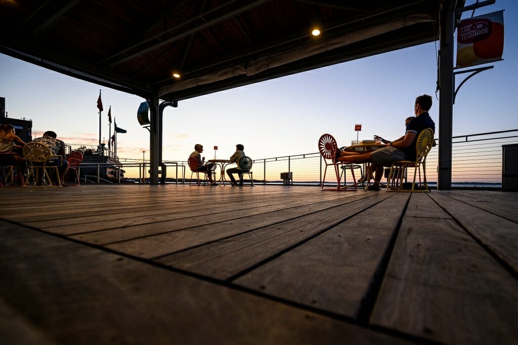 People sit under the gazebo on the Terrace.