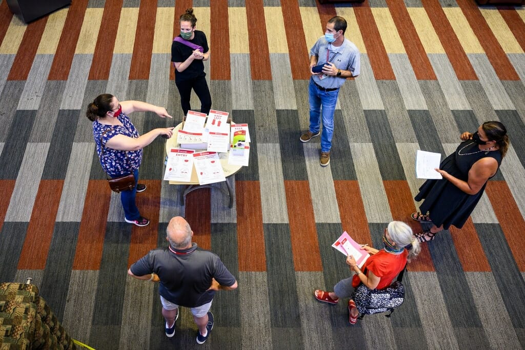 Members of a facilities planning committee meet to test installation of new Smart Restart building signage at the Health Sciences Learning Center.