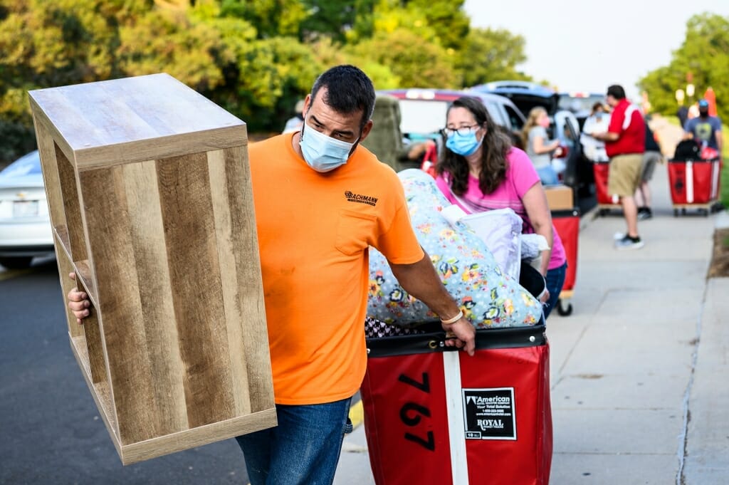 Mark and Vicki Chrostowski cart belongings as they help their daughter Maggie move in. Vicki Chrostowski is a 1998 UW-Madison alumnae.