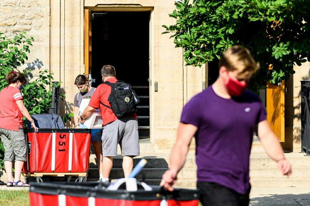 Students move into Tripp-Adams Residence Hall with the help of carts.