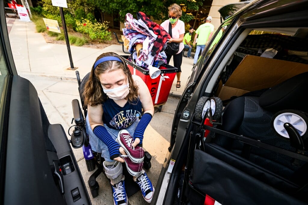 Maria Pesick of Wales, Wis., gathers her collection of Converse shoes while moving in to Smith Residence Hall.