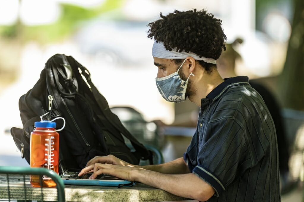 Student Ngaru Nen took advantage of the pleasant weather to study outside on Engineering Mall.