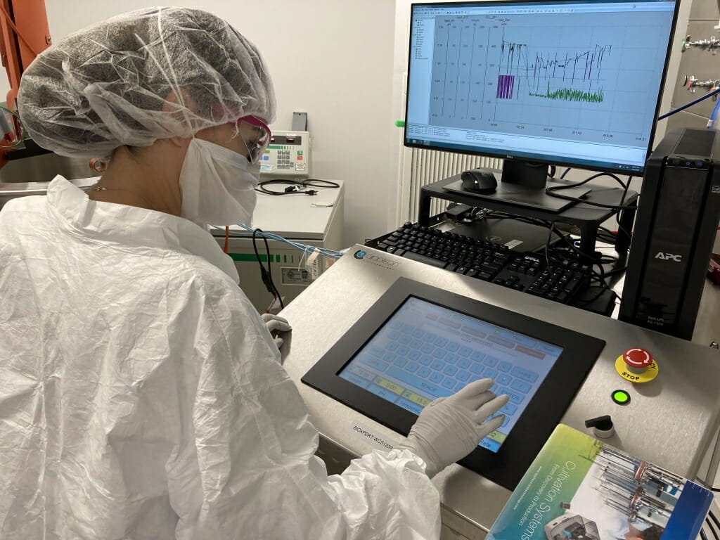 Rachel Mosher adjusts the controls on a production bioreactor