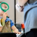 Child looking through magnifying glass